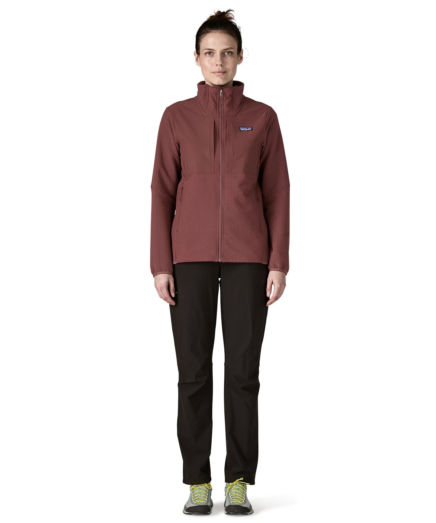 A woman wearing the Patagonia R2 crossstrata jacket in dark ruby available at Babipur. Features a full length zip, 2 side pockets and easy access chest pockets
