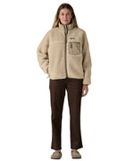 A woman wearing the Patagonia classic retro x women's jacket in natural available at Babipur. 