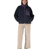 A woman wearing the Patagonia classic retro x women's jacket in sunken blue available at Babipur. 