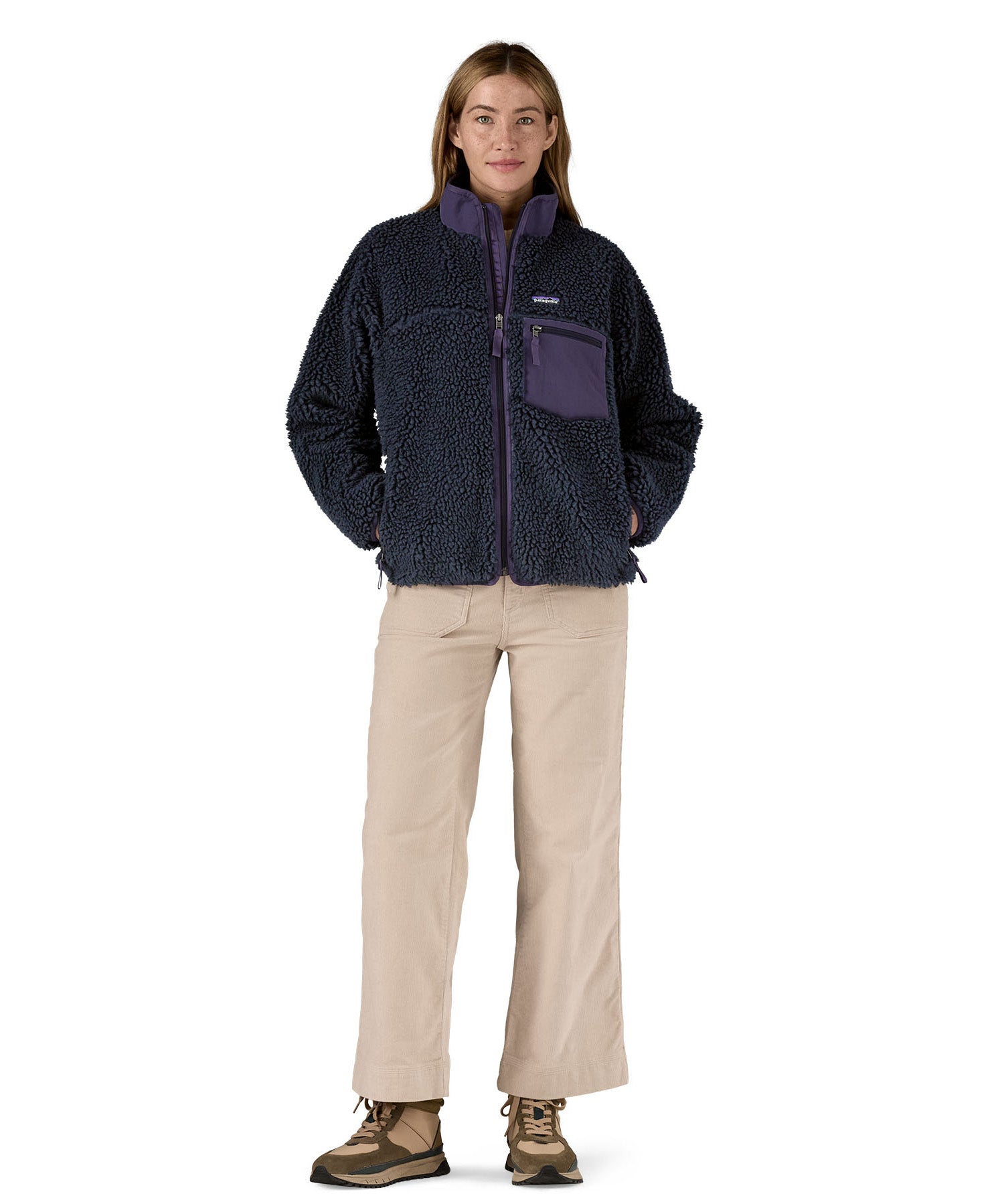 A woman wearing the Patagonia classic retro x women's jacket in sunken blue available at Babipur. 