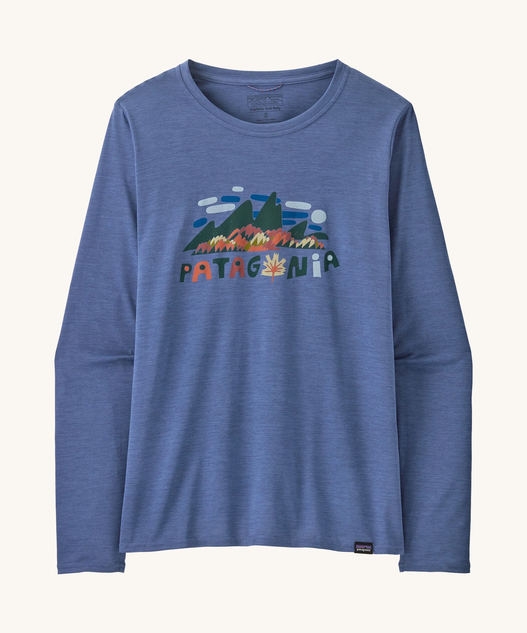 Front view of the Patagonia Women’s Long Sleeved Capilene Cool Daily Graphic Shirt in Fitz Roy Foliage Current Blue X-Dye, showing the mountain scene graphic and Patagonia logo on the chest.