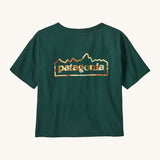 Patagonia women's unity Fitz roy responsibili tshirt. A green, short sleeved and boxy top with the brand logo printed on the front. 