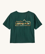 Patagonia women's unity Fitz roy responsibili tshirt. A green, short sleeved and boxy top with the brand logo printed on the front. 