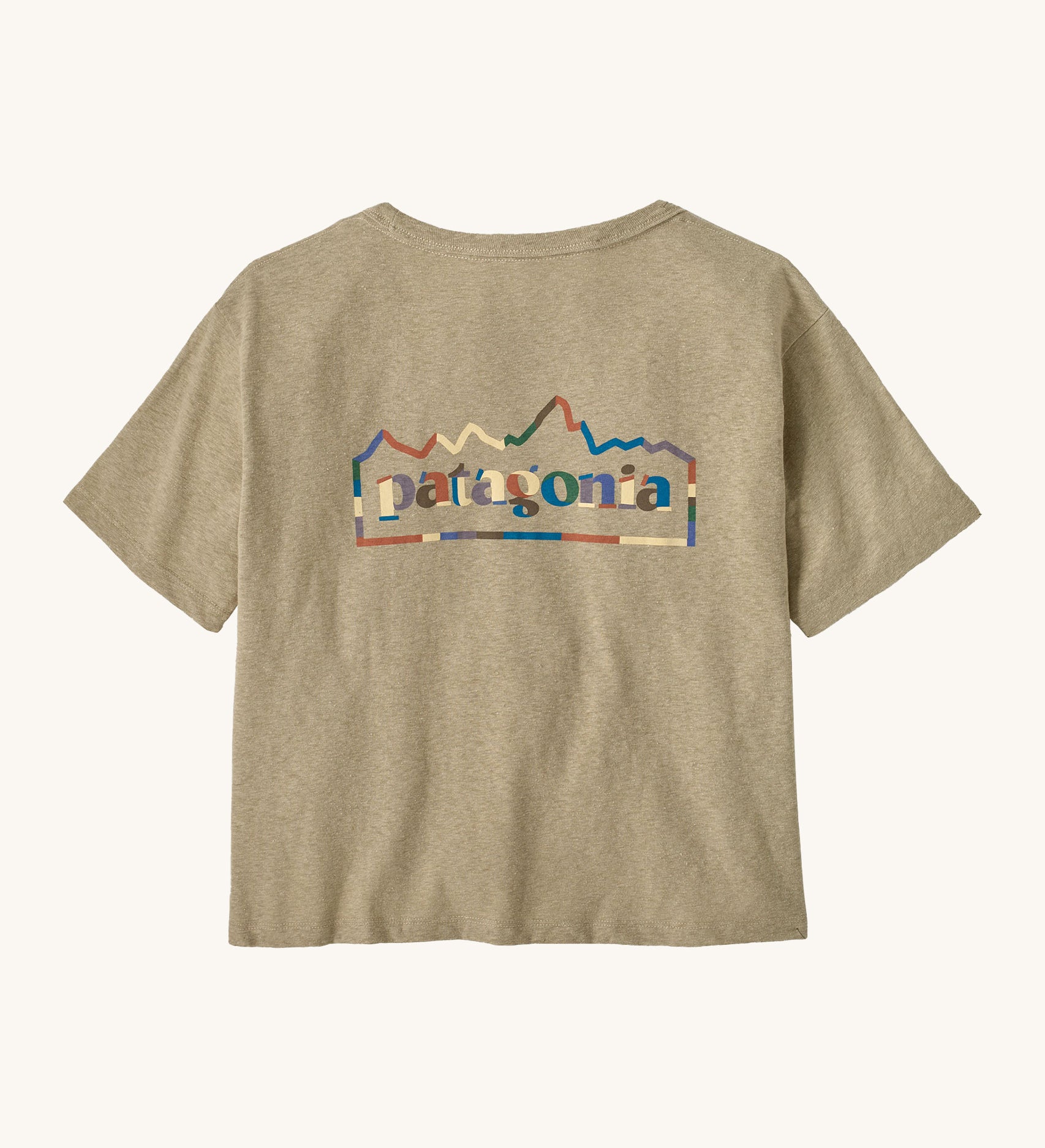 Patagonia women's unity Fitz roy responsibili tshirt. A light brown, short sleeved and boxy top with the brand logo printed on the front. 