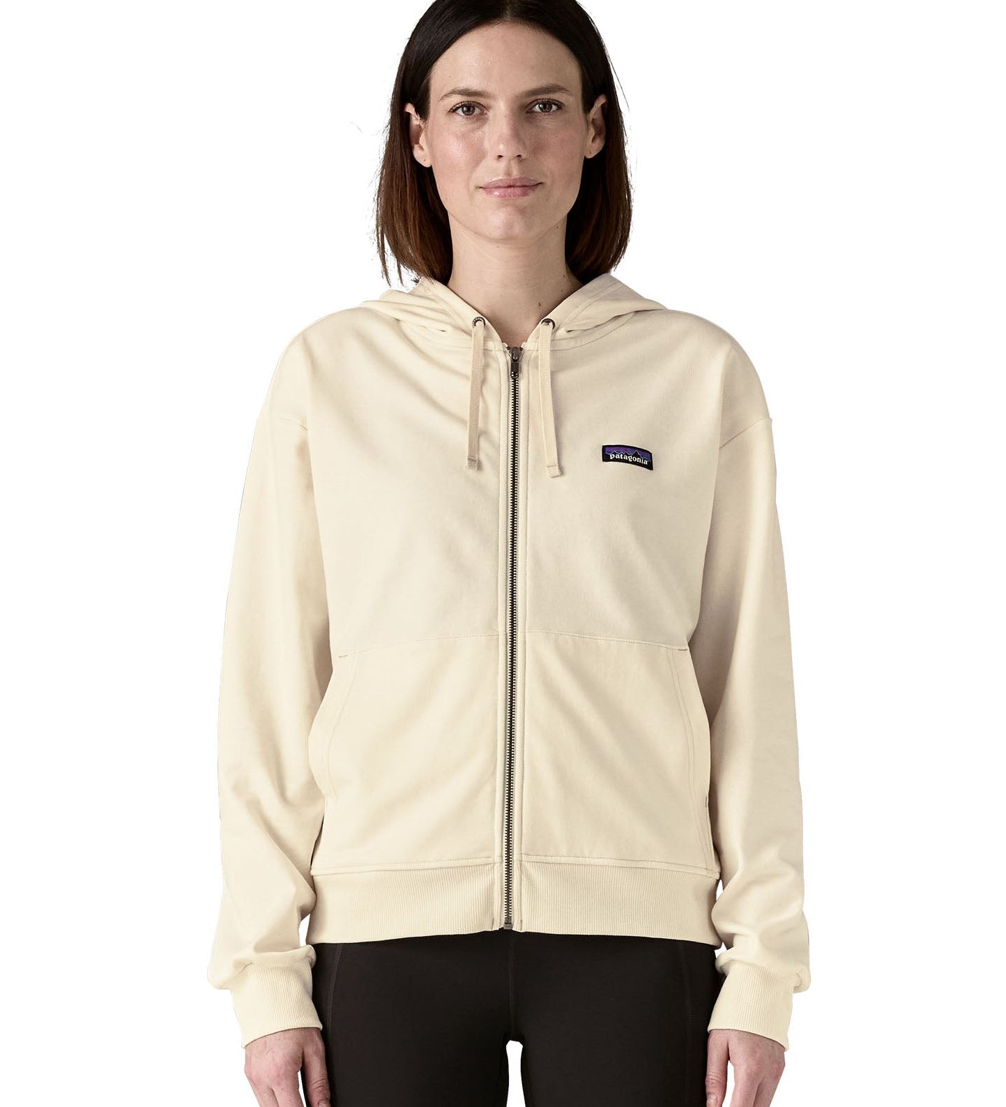 Woman wearing Patagonia women's full zip Anhya hoody in cream. Hoody has a relaxed fit and sit at the hips