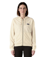 Woman wearing Patagonia women's full zip Anhya hoody in cream. Hoody has a relaxed fit and sit at the hips