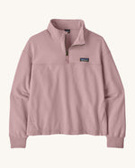 Patagonia women's Ahnya pullover sweater in pale purple. Shows a 1/4 length zip and side pockets