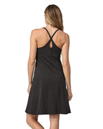 Back of woman wearing Patagonia's amber dawn organic cotton dress in black. Shows cross over shoulder straps