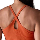 Back of woman wearing Patagonia's amber dawn sleeveless dress in orange. Shows cross shoulder strap 
