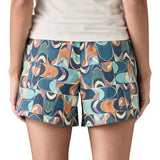 Back of woman Patagonia quick drying baggies shorts in blue with a repeating abstract design. Shows 2 front pockets and elasticated waistband