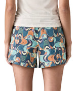 Back of woman Patagonia quick drying baggies shorts in blue with a repeating abstract design. Shows 2 front pockets and elasticated waistband