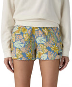 Front of woman wearing the Patagonia quick drying barely baggies shorts in blue with a repeating abstract floral design