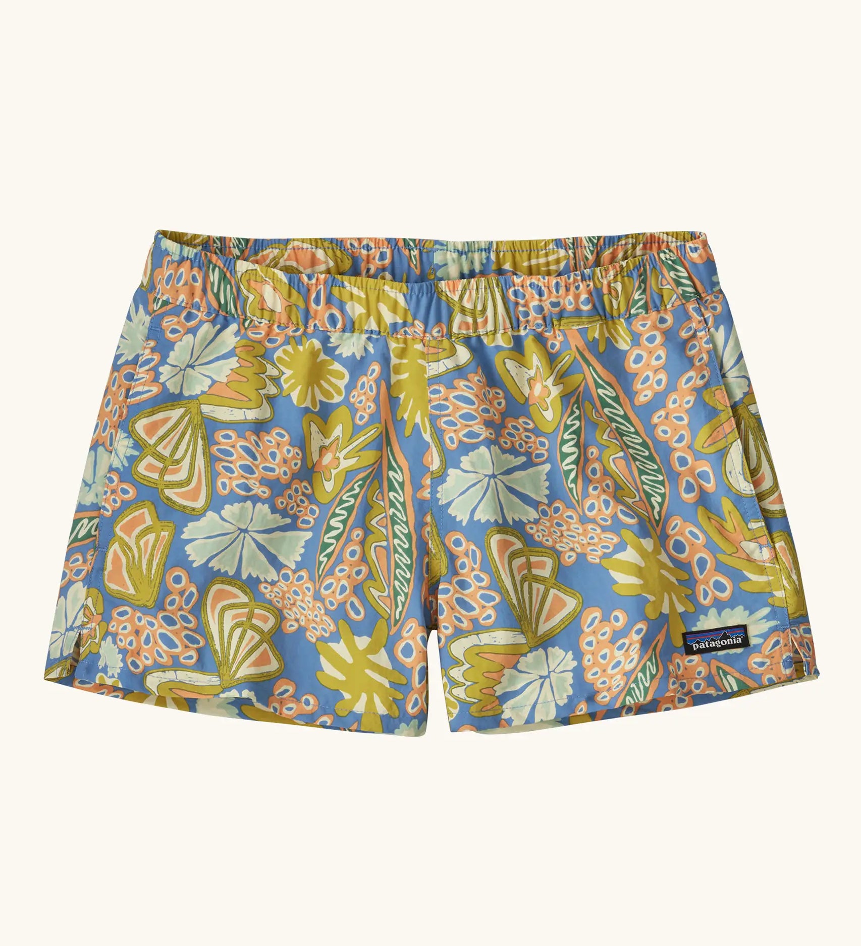 Patagonia quick drying women's barely baggies shorts in blue with a repeating abstract floral design. Shows 2 side pockets and elasticated waist band