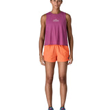 Woman wearing Patagonia's quick drying women's barely baggies shorts in bright orange 