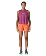 Woman wearing Patagonia's quick drying women's barely baggies shorts in bright orange 
