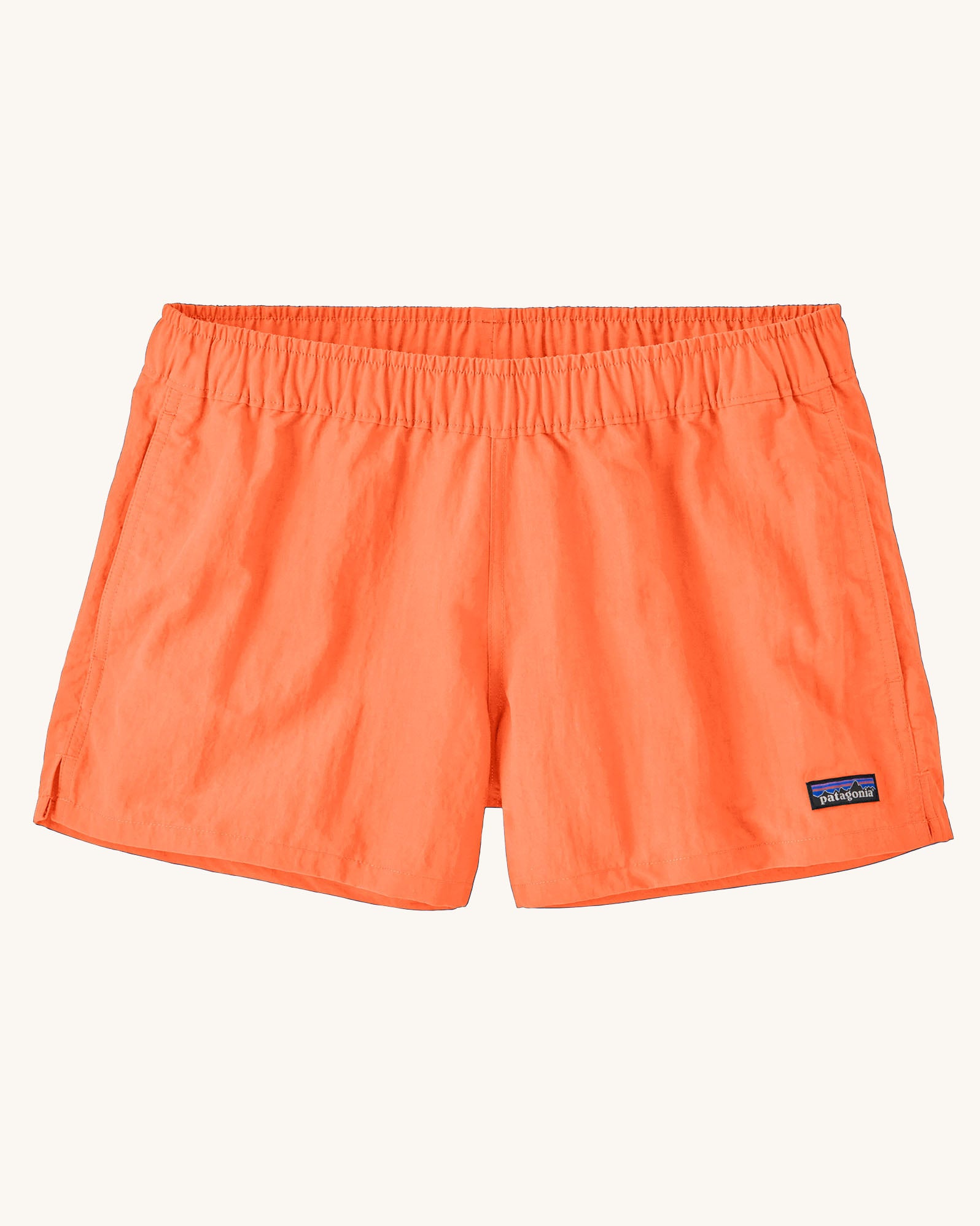 Patagonia quick drying women's barely baggies shorts in bright orange. Shows 2 side pockets and elasticated waist band