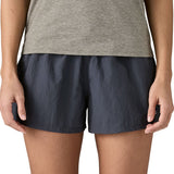 Front of woman wearing Patagonia'squick drying women's barely baggies shorts in navy blue. Shorts have a loose fit
