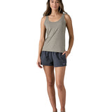 Woman wearing Patagonia's quick drying women's barely baggies shorts in navy blue with hand in side pocket. 