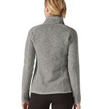 The back of a woman wearing Patagonia's women's better sweater jacket in grey. The jacket has a regular fit 