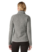 The back of a woman wearing Patagonia's women's better sweater jacket in grey. The jacket has a regular fit 