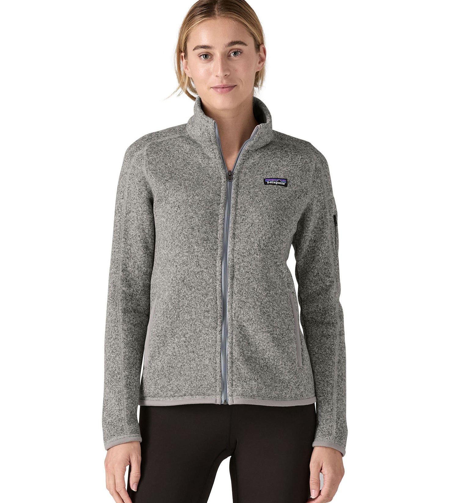 Woman wearing Patagonia's women's better sweater jacket in grey. Jacket has a regular fit and sits at the hips.