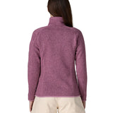 Back of woman wearing Patagonia's women's better sweater jacket in purple. The jacket has a regular fit 