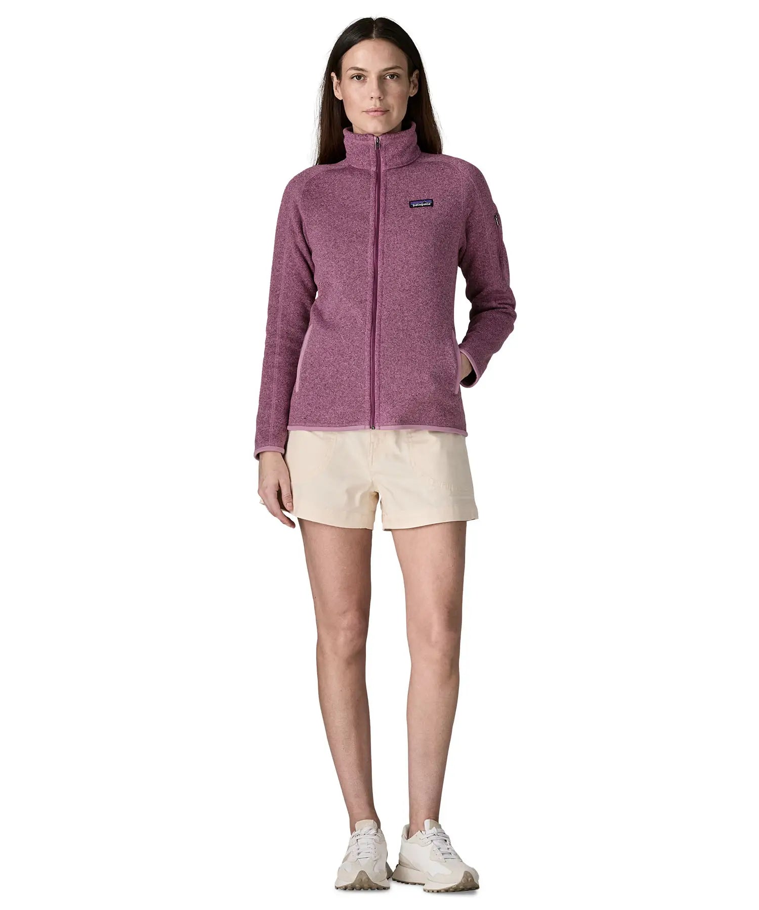 Back of woman wearing Patagonia's women's better sweater jacket in purple showing full length front zip. The jacket has a regular fit 