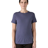 Woman wearing Patagonia's capilene merino blend short sleeve technical t-shirt in solstice purple. Top has a slim fit