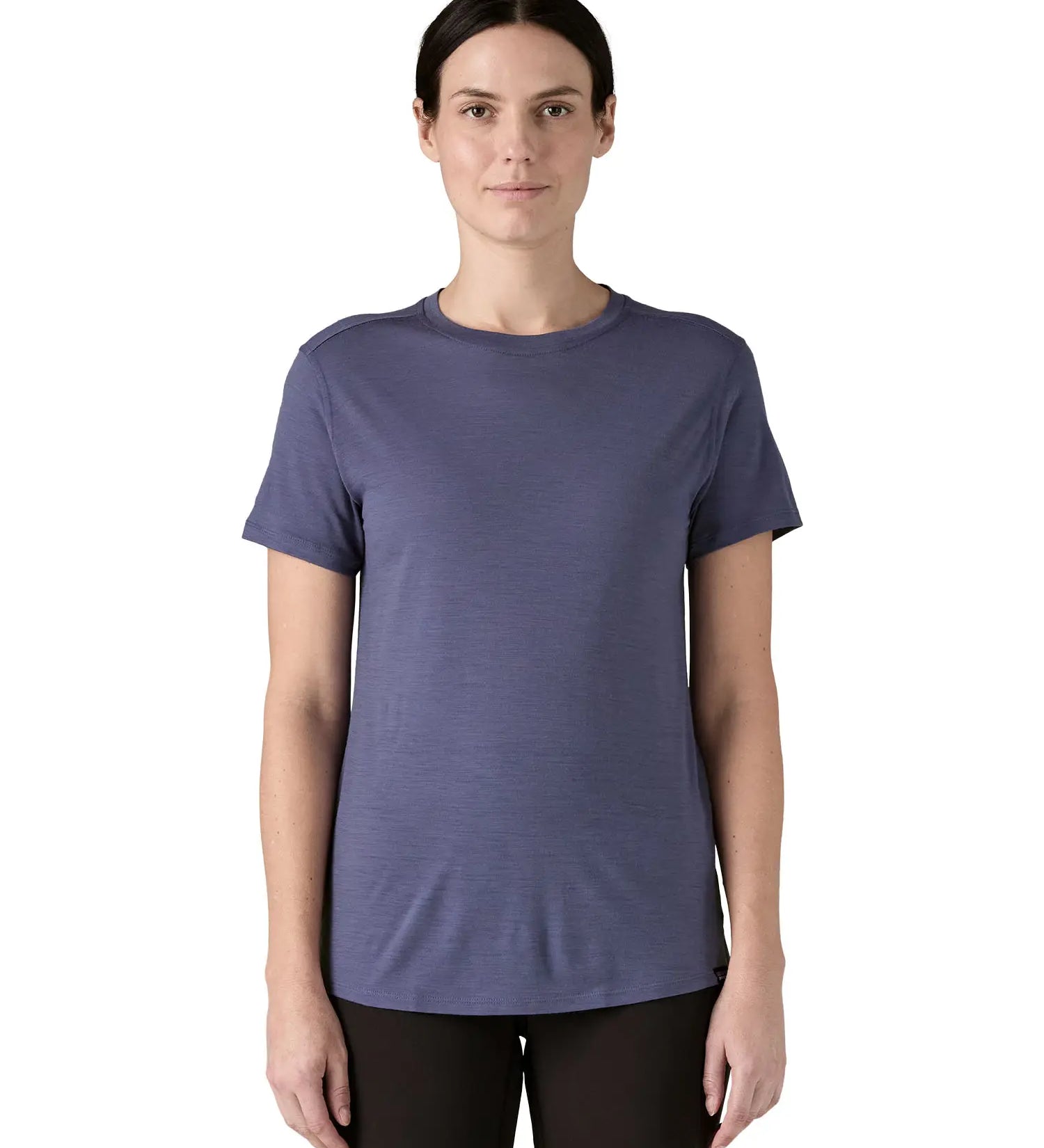 Woman wearing Patagonia's capilene merino blend short sleeve technical t-shirt in solstice purple. Top has a slim fit