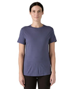Woman wearing Patagonia's capilene merino blend short sleeve technical t-shirt in solstice purple. Top has a slim fit
