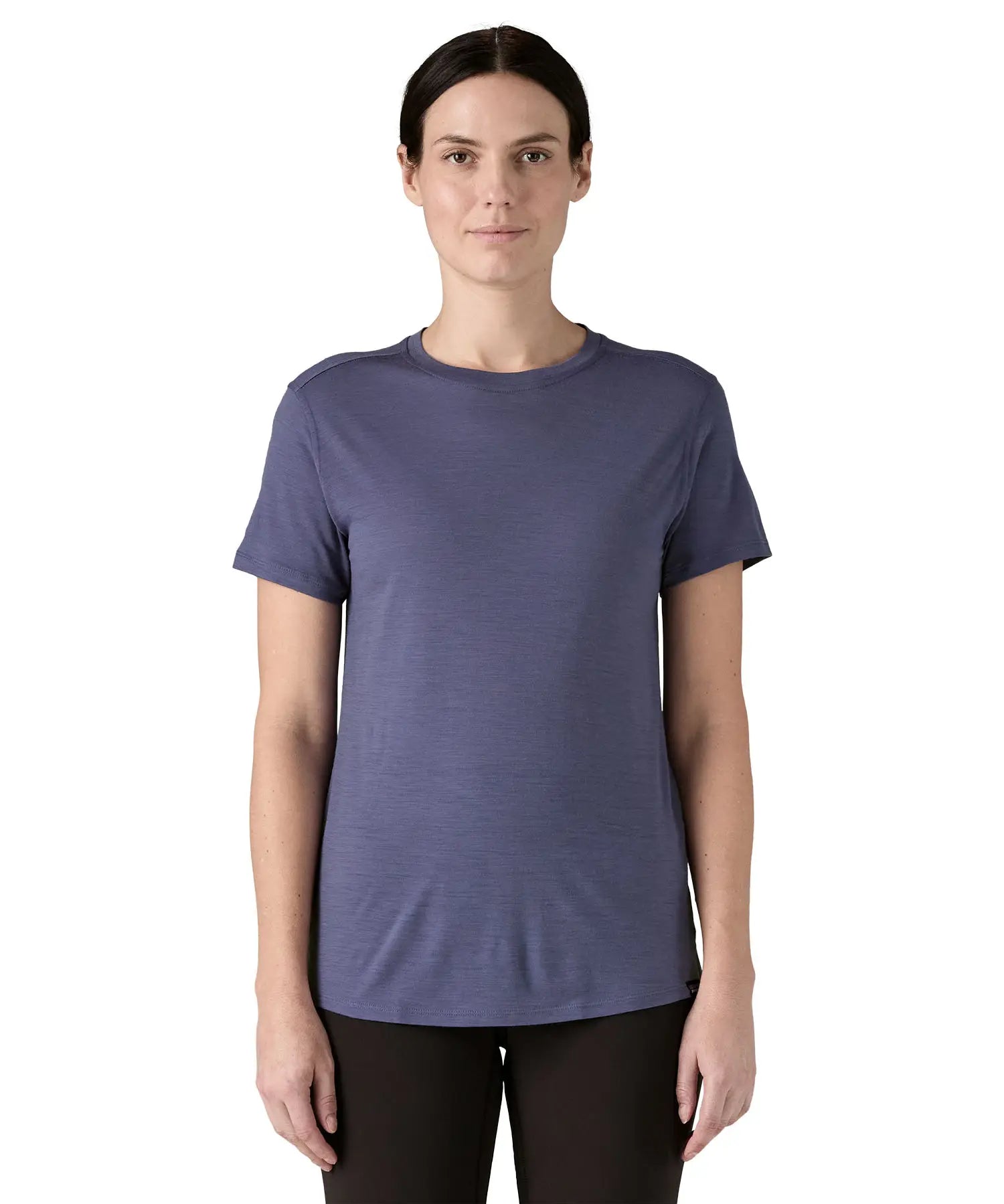 Woman wearing Patagonia's capilene merino blend short sleeve technical t-shirt in solstice purple. Top has a slim fit