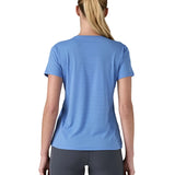 Back of woman wearing Patagonia's technical capilene cool lightweight t-shirt in light blue. 