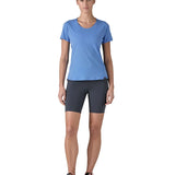 Woman wearing Patagonia's technical capilene cool lightweight t-shirt in light blue. Top has a slim fit and sits at the hips