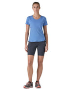 Woman wearing Patagonia's technical capilene cool lightweight t-shirt in light blue. Top has a slim fit and sits at the hips