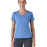 Woman wearing Patagonia's technical capilene cool lightweight t-shirt in light blue. Top has a slim fit