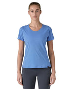 Woman wearing Patagonia's technical capilene cool lightweight t-shirt in light blue. Top has a slim fit