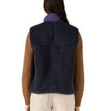 A model wearing the Patagonia womens classic retro x fleece vest available at Babipur showing the back fit of the gilet