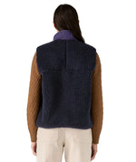 A model wearing the Patagonia womens classic retro x fleece vest available at Babipur showing the back fit of the gilet