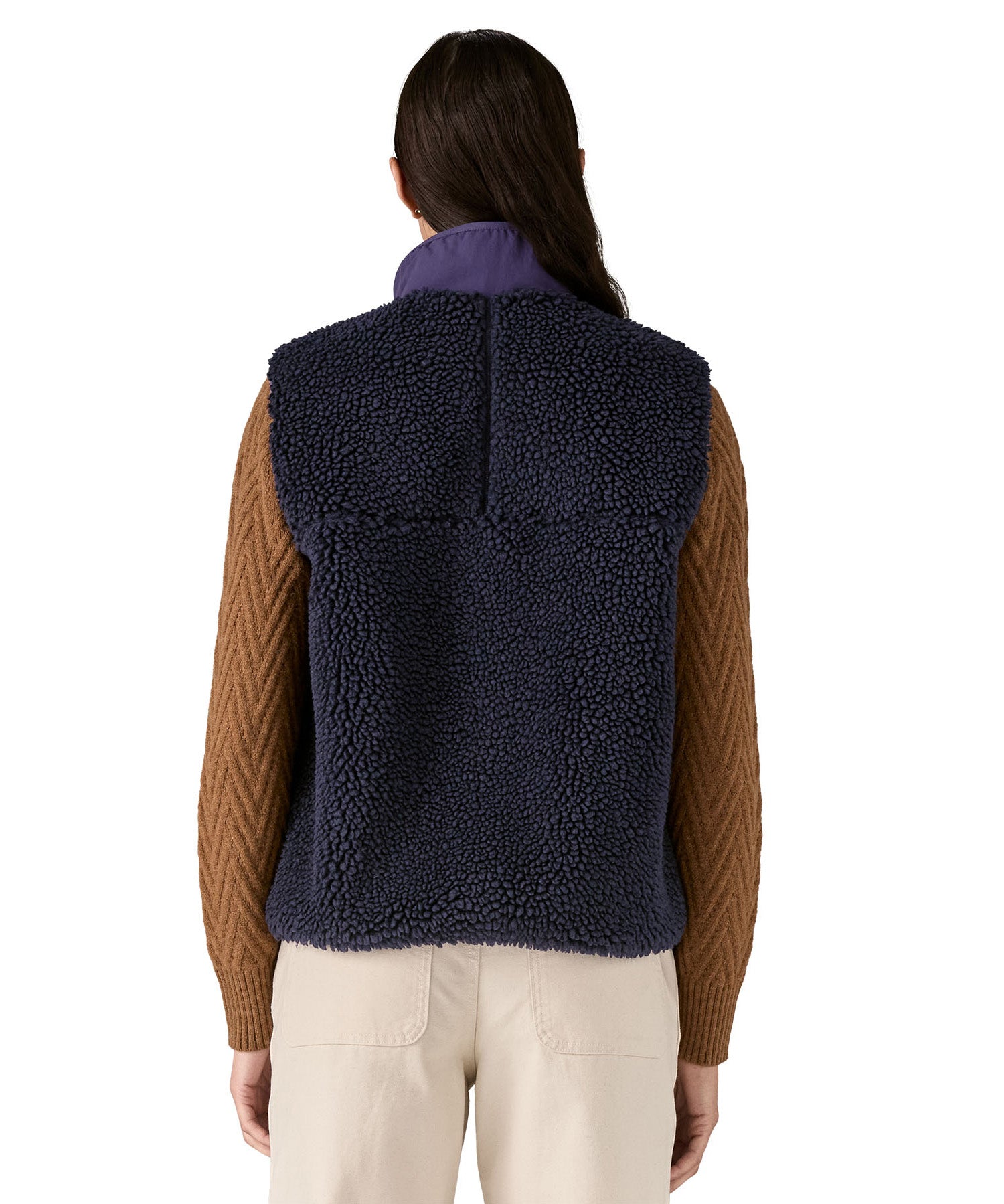 A model wearing the Patagonia womens classic retro x fleece vest available at Babipur showing the back fit of the gilet