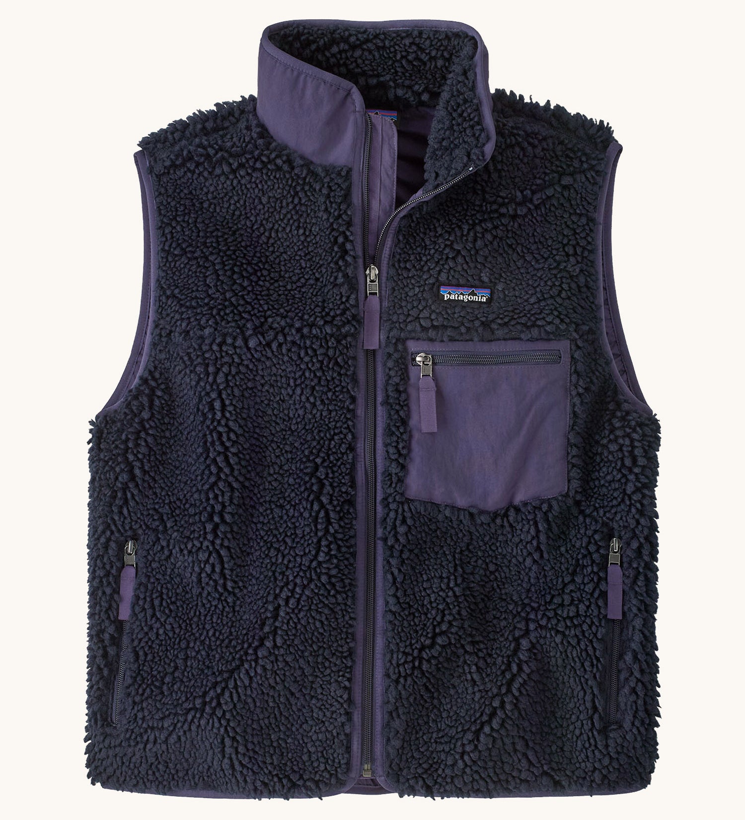 Patagonia womens classic retro x fleece vest available at Babipur. A dark blue coloured thick fleece gilet with a dark purple trim. Features a full length zip, chest pocket and side pockets