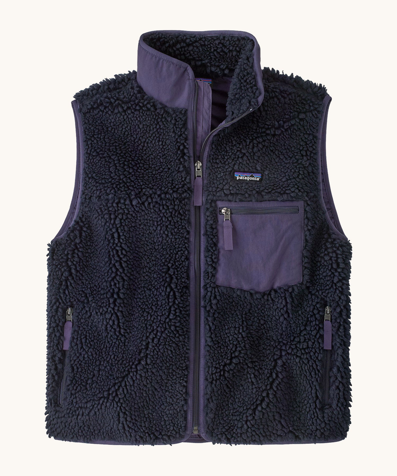 Patagonia womens classic retro x fleece vest available at Babipur. A dark blue coloured thick fleece gilet with a dark purple trim. Features a full length zip, chest pocket and side pockets