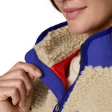 A close up of the A Patagonia women's classic retro-x jacket in a dark natural colour way available at Babipur showing the royal blue zip trim detail