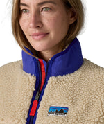 A close up of the A Patagonia women's classic retro-x jacket in a dark natural colour way available at Babipur showing the royal blue turn up collar detail