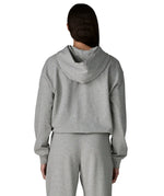 Back of woman wearing Patagonia's daily hoody in grey. Hoody has a relaxed fit and sits around the hips