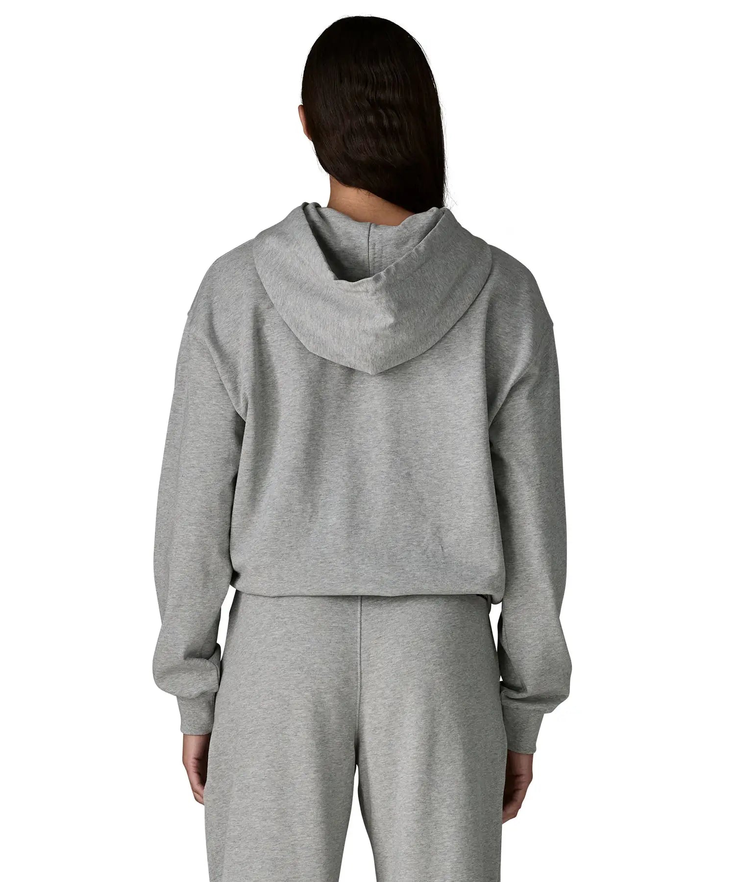 Back of woman wearing Patagonia's daily hoody in grey. Hoody has a relaxed fit and sits around the hips
