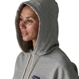 Woman wearing Patagonia's daily hoody in grey showing close up of the hood over the head 
