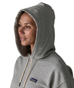 Woman wearing Patagonia's daily hoody in grey showing close up of the hood over the head 