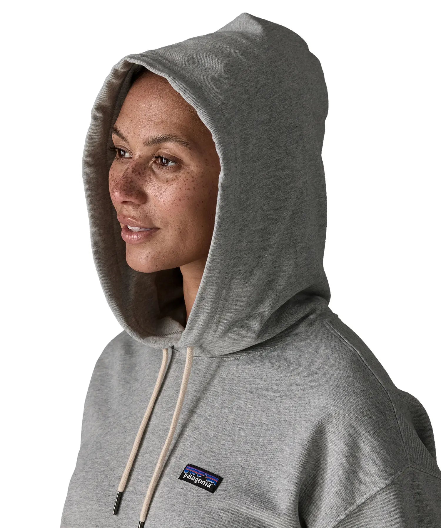 Woman wearing Patagonia's daily hoody in grey showing close up of the hood over the head 