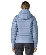 Back of woman wearing the Patagonia down insulated sweater hoody jacket in barnacle blue.