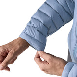 Woman wearing the Patagonia down insulated sweater hoody in barnacle blue showing close up of cuff trim